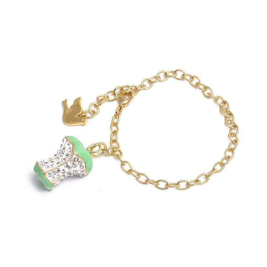 Gold bracelet with a gold dove charm and green apple bitten to the core with clear rhinestones.
